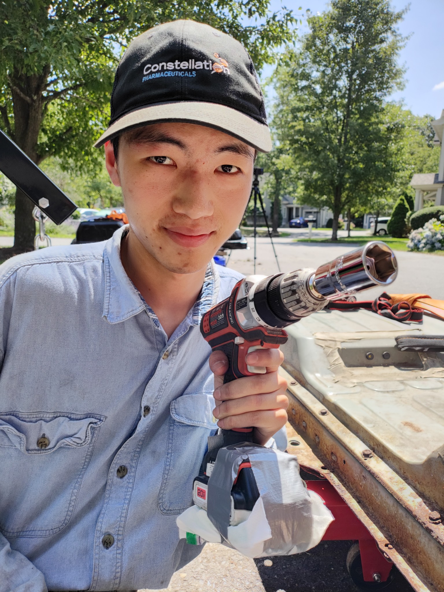 Me, holding up a drill cooled down with ice, secured with duct tape, the Greatest American Invention of All Time